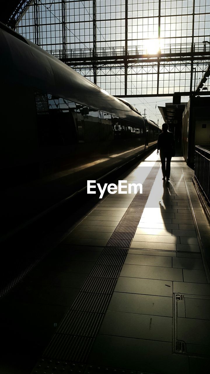 WOMAN AT RAILROAD STATION PLATFORM