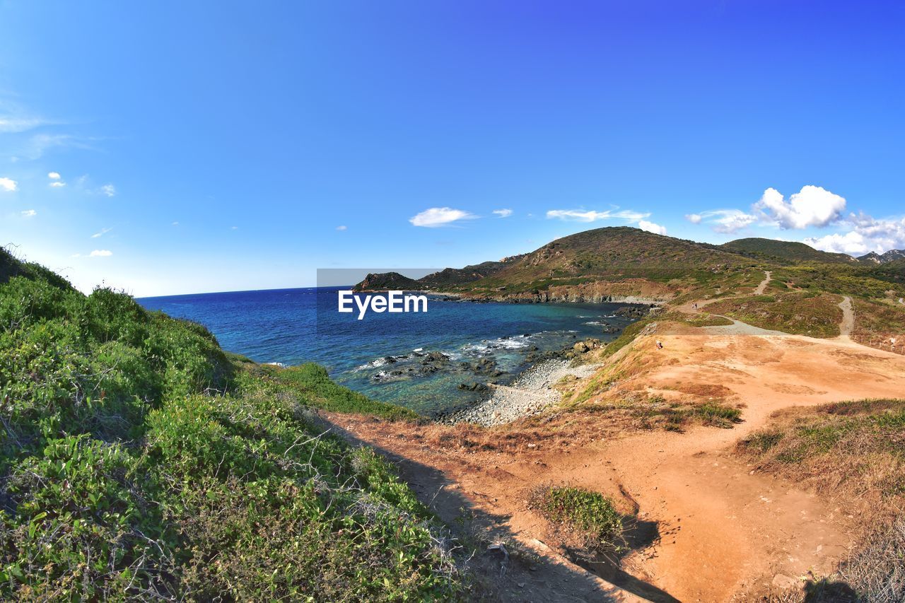 water, sky, land, sea, coast, scenics - nature, nature, beauty in nature, beach, environment, landscape, mountain, travel destinations, blue, travel, tranquility, ocean, no people, shore, cliff, body of water, plant, terrain, tranquil scene, coastline, tourism, vacation, bay, outdoors, cloud, day, holiday, tree, trip, sand, non-urban scene, sunny, clear sky, idyllic, summer, sunlight