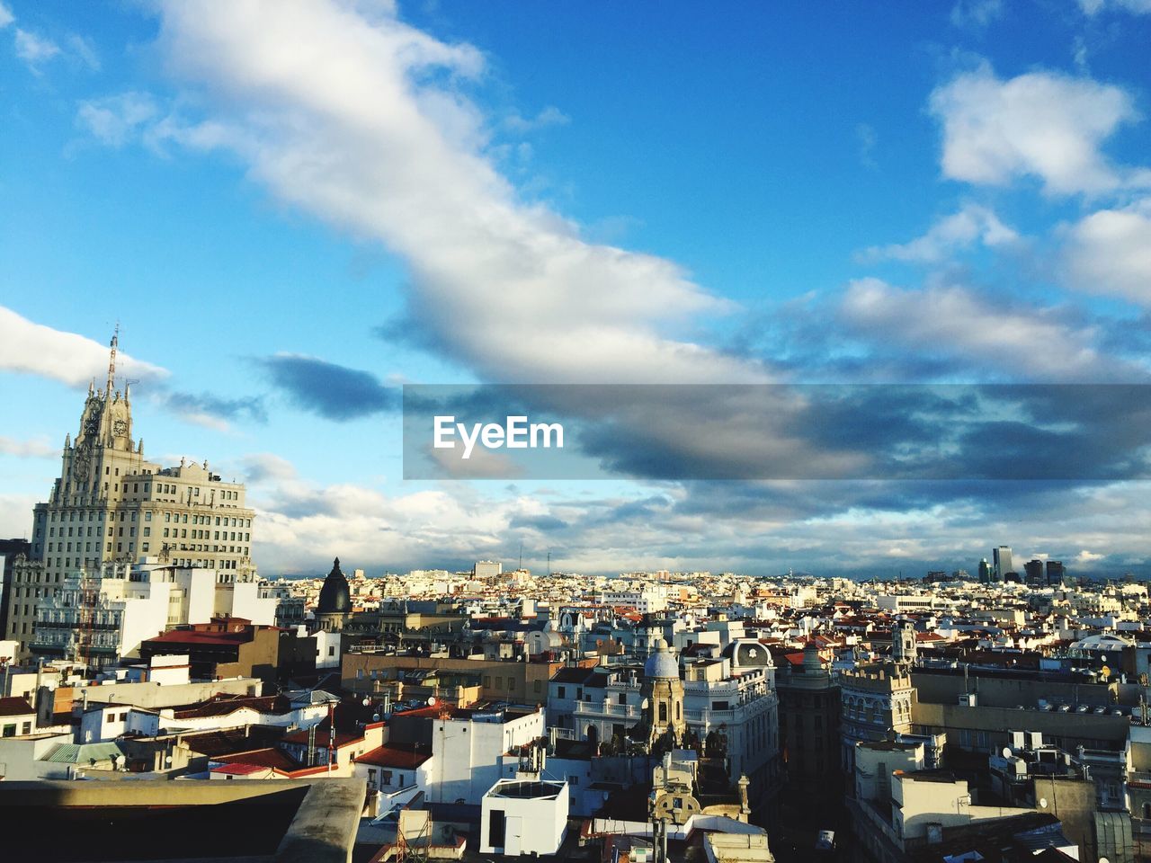 Cityscape against cloudy sky