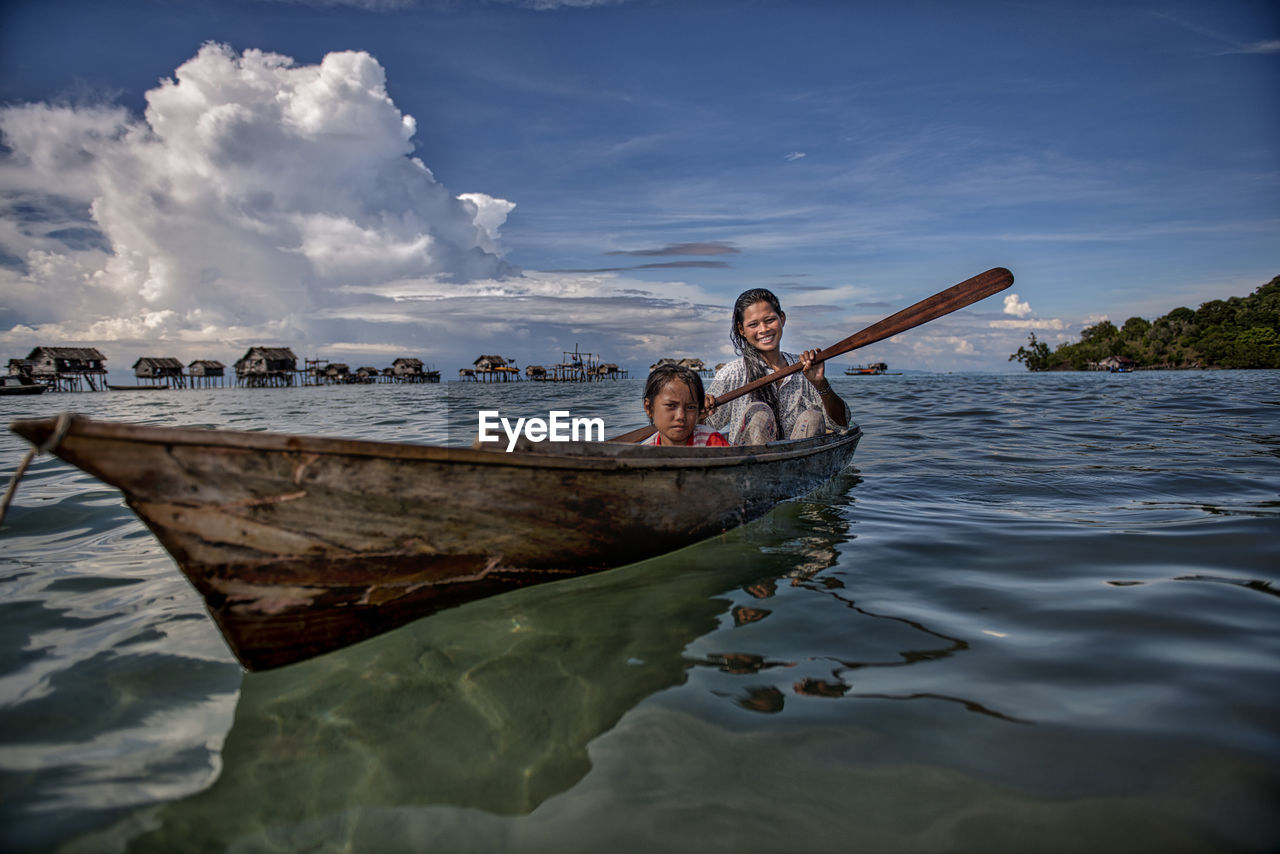 PEOPLE ON BOAT AGAINST SEA