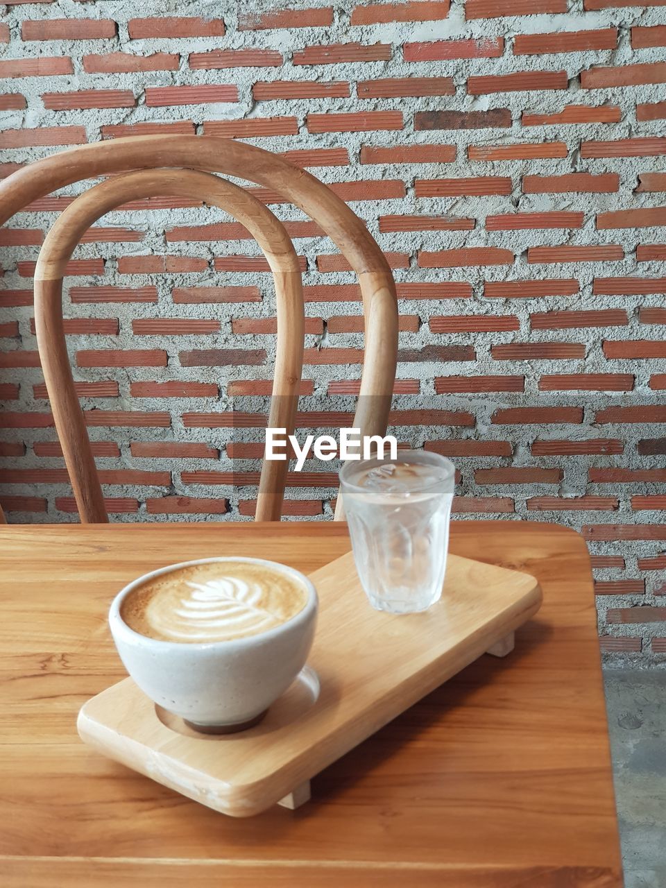 COFFEE CUP ON TABLE AGAINST WALL