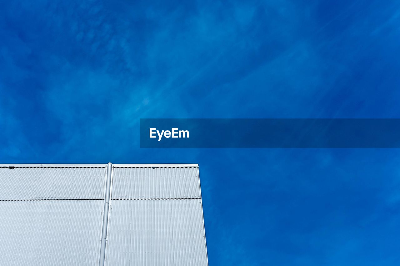 Low angle view of theatre building against blue sky