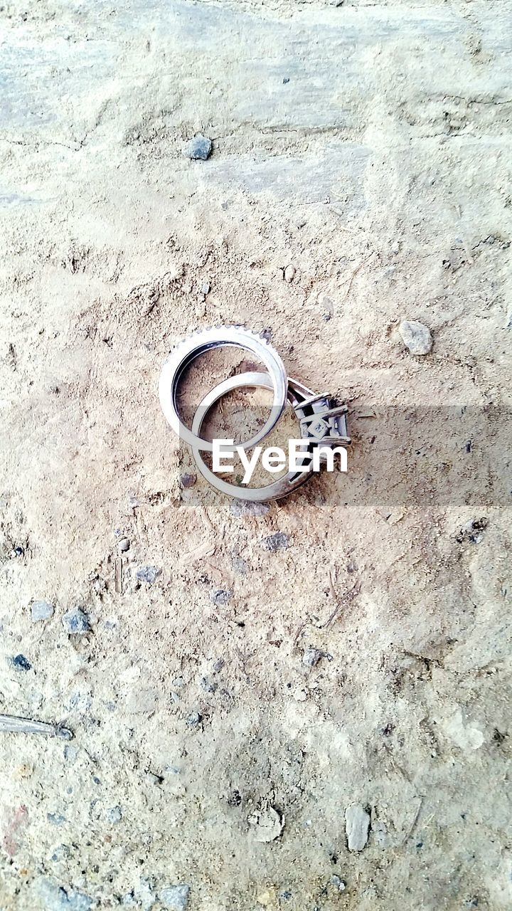 High angle view of wedding rings on field