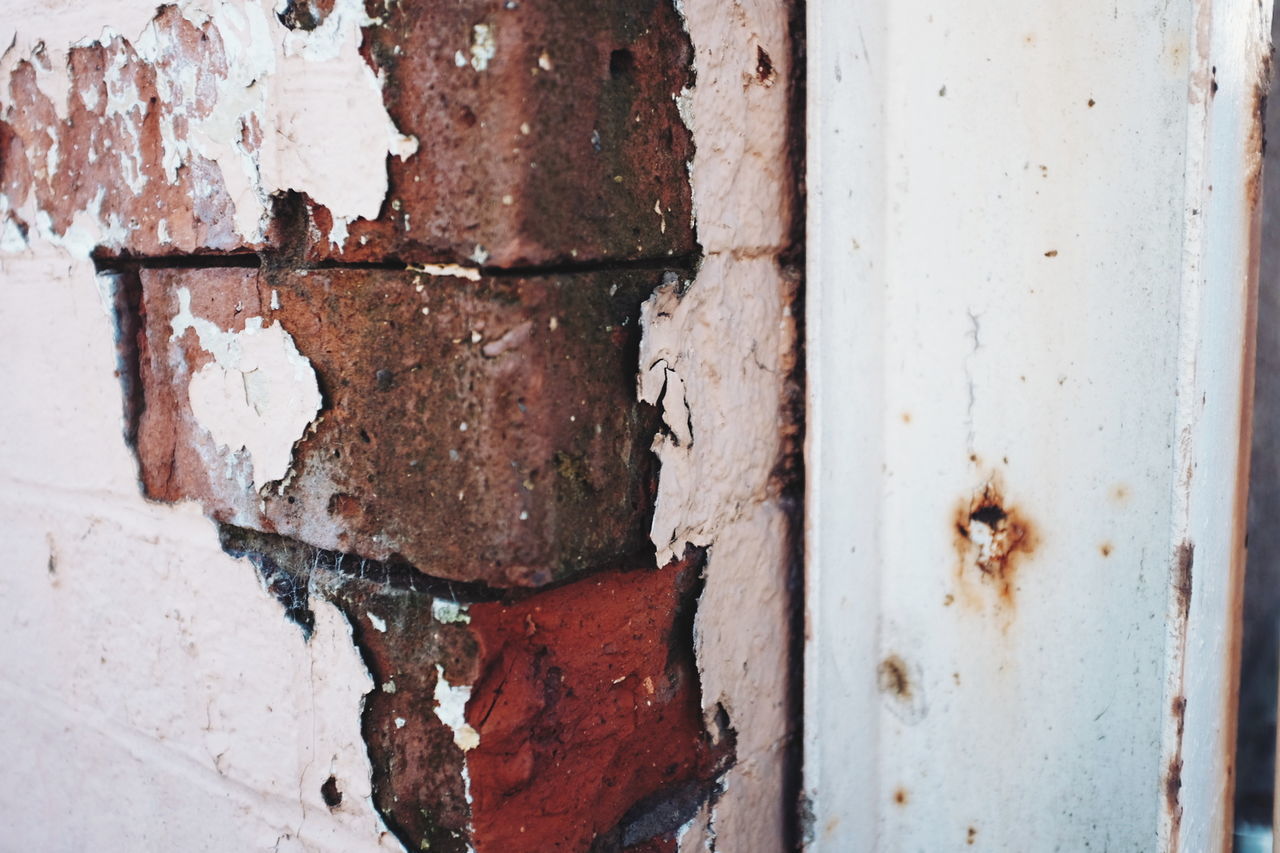 Close-up of damaged brick wall