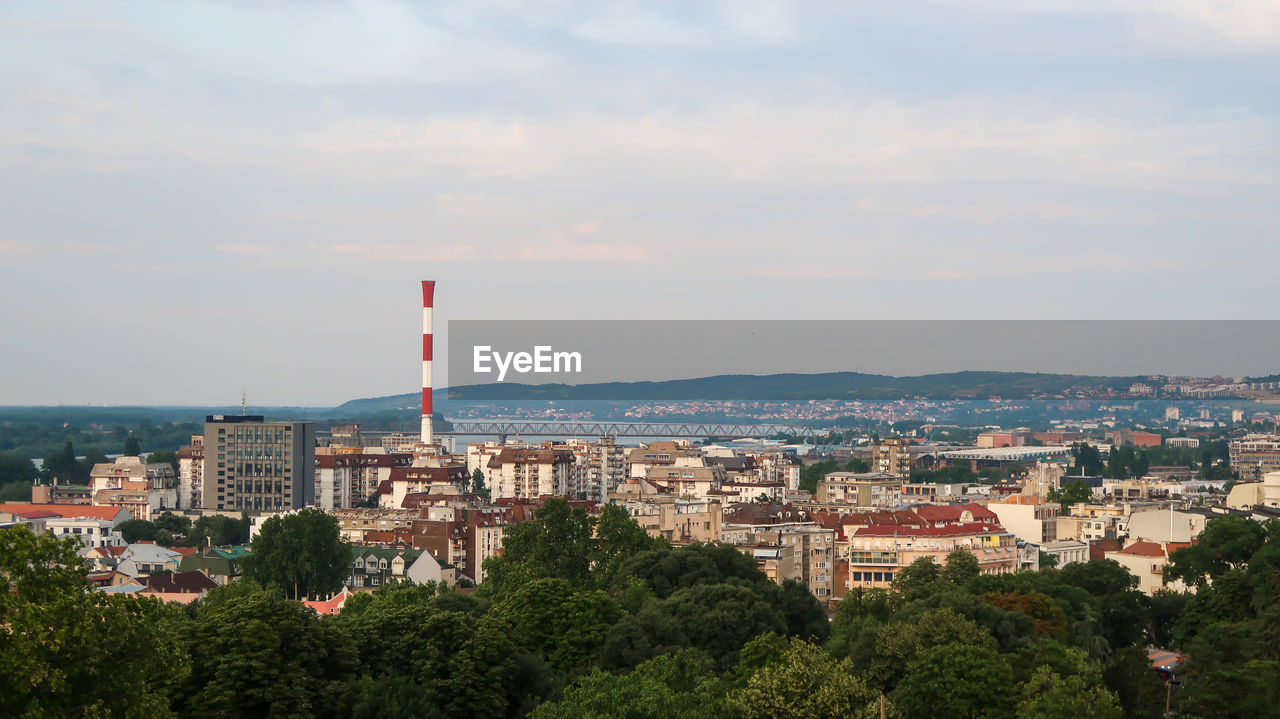 architecture, building exterior, built structure, skyline, city, sky, horizon, building, urban area, cityscape, nature, hill, tower, cloud, tree, no people, aerial photography, landmark, downtown, day, town, high angle view, residential district, skyscraper, plant, outdoors, travel destinations, landscape, flag, tower block, morning, travel, office building exterior