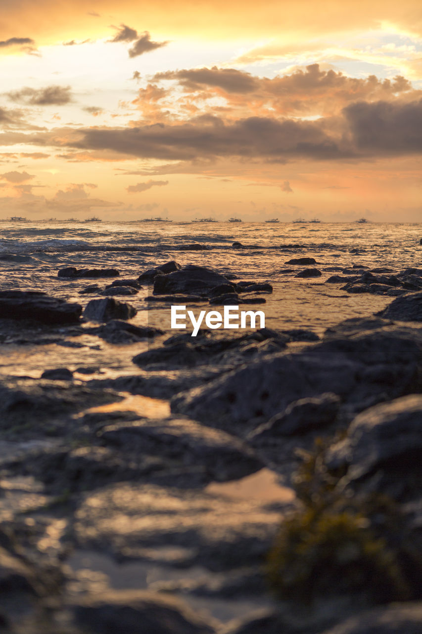 SCENIC VIEW OF SEA AGAINST ORANGE SKY