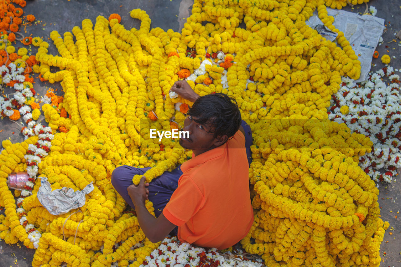     holding yellow flowers