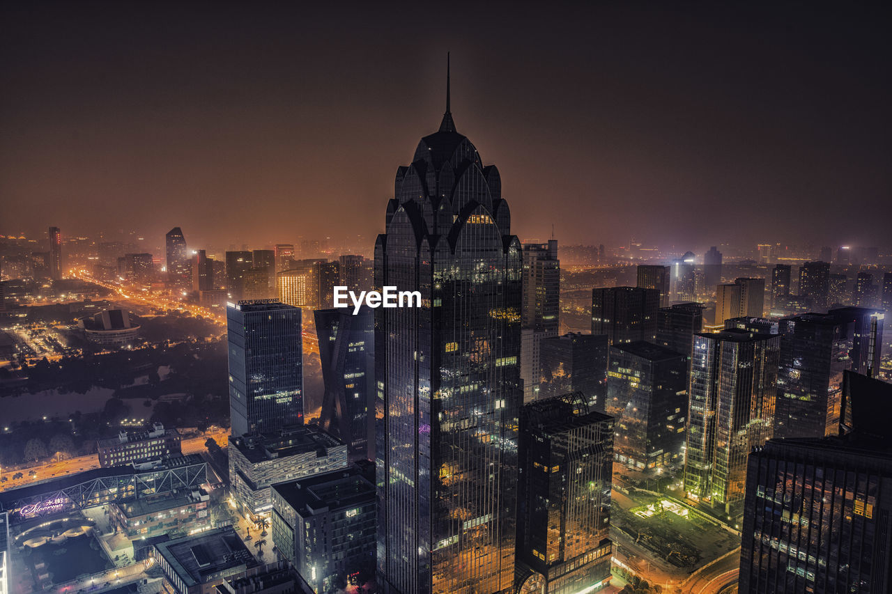 Aerial view of buildings in city at night