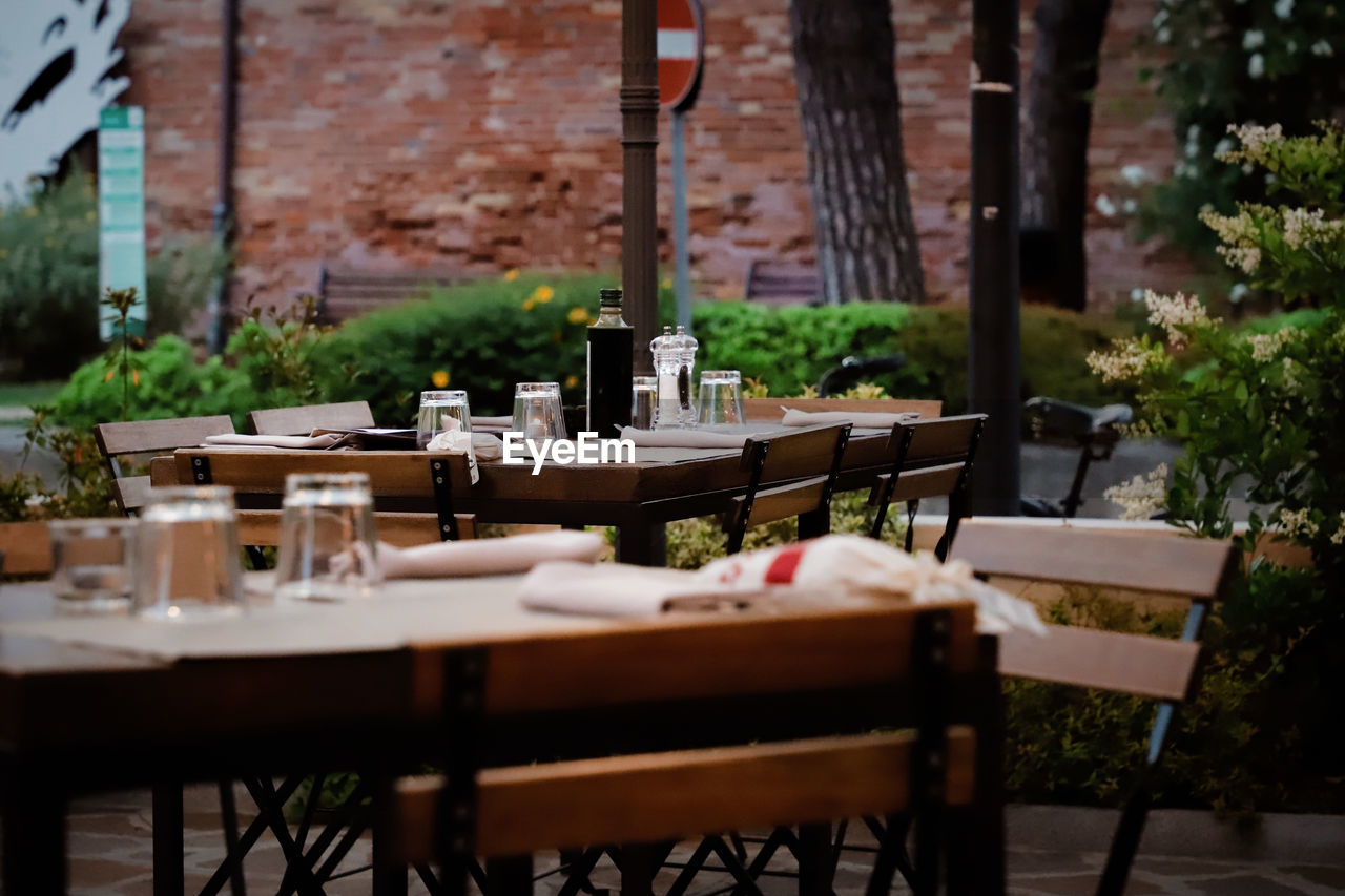 Cervia Sitting Outside Absence Architecture Chair Day Food Food And Drink Freshness Furniture Glass Household Equipment Italy Nature No People Outdoors Place Setting Plant Restaurant Seat Selective Focus Setting Table Wood - Material