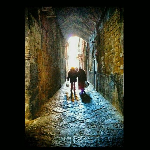 WOMAN WALKING IN TUNNEL