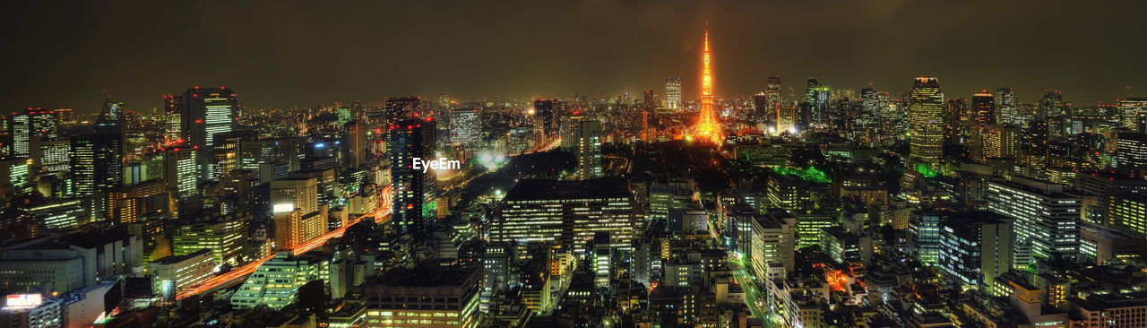 High angle view of illuminated modern buildings in city at night