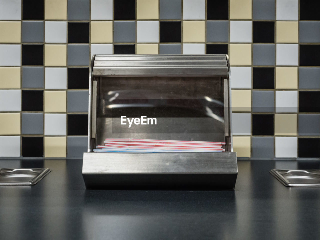 Close-up of drinking straw dispenser in fast food restaurant