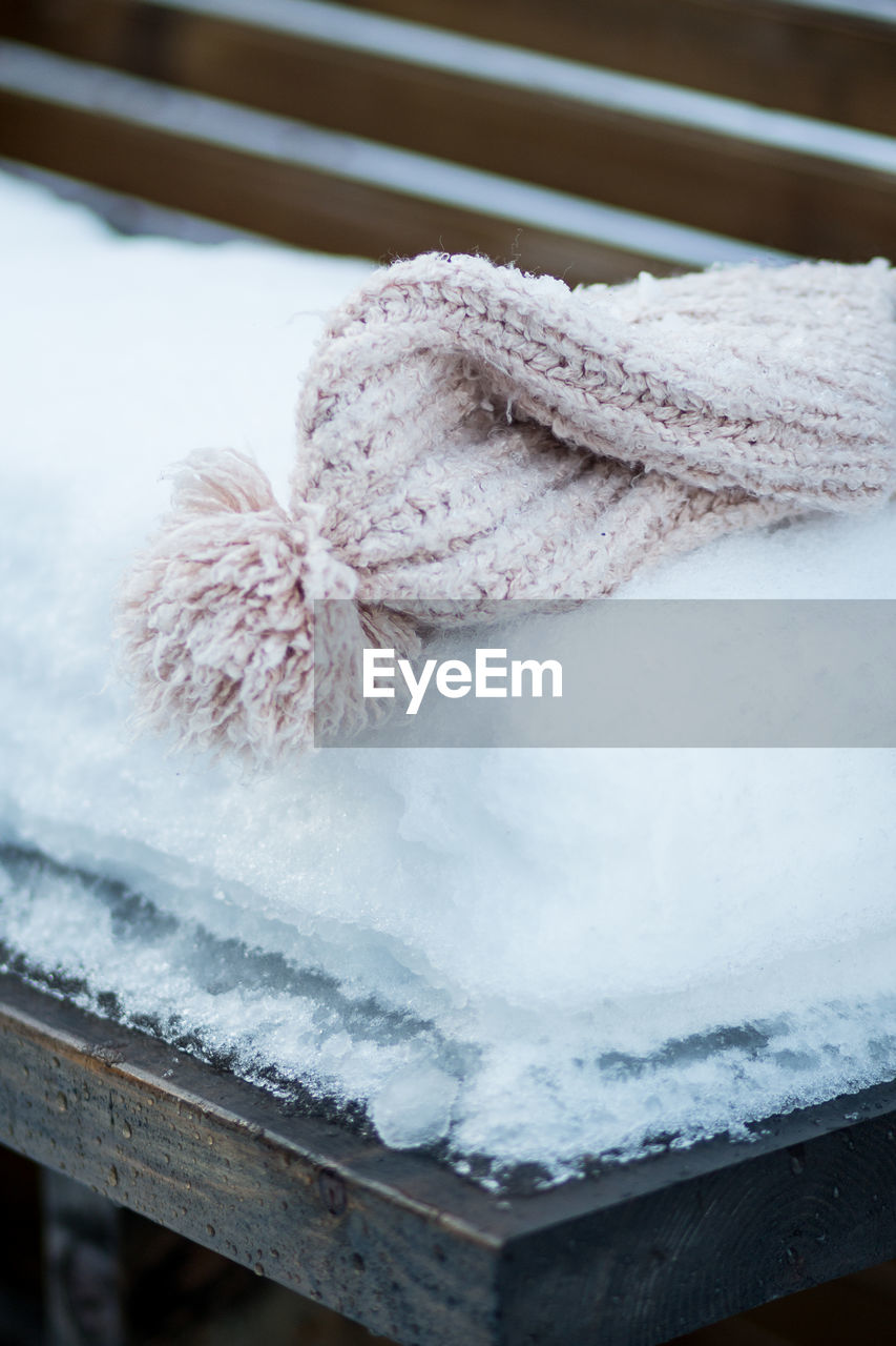 Close-up of snow and hat