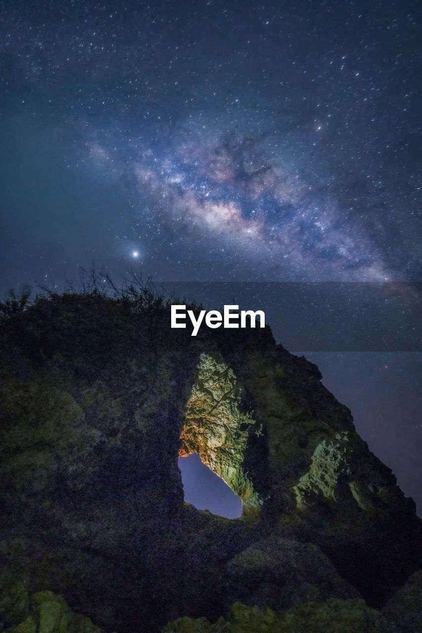 SCENIC VIEW OF ROCK FORMATION AGAINST STAR FIELD