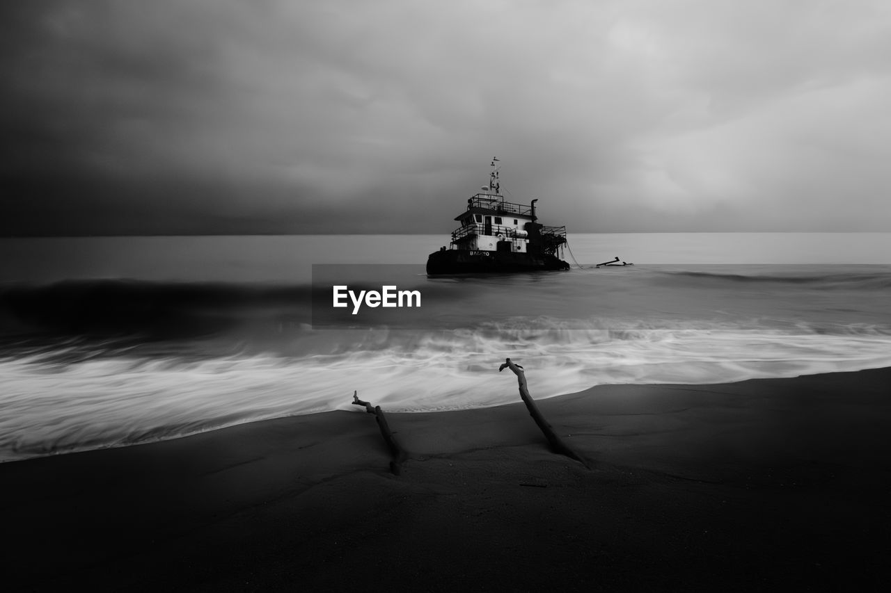 boat sailing on sea against sky