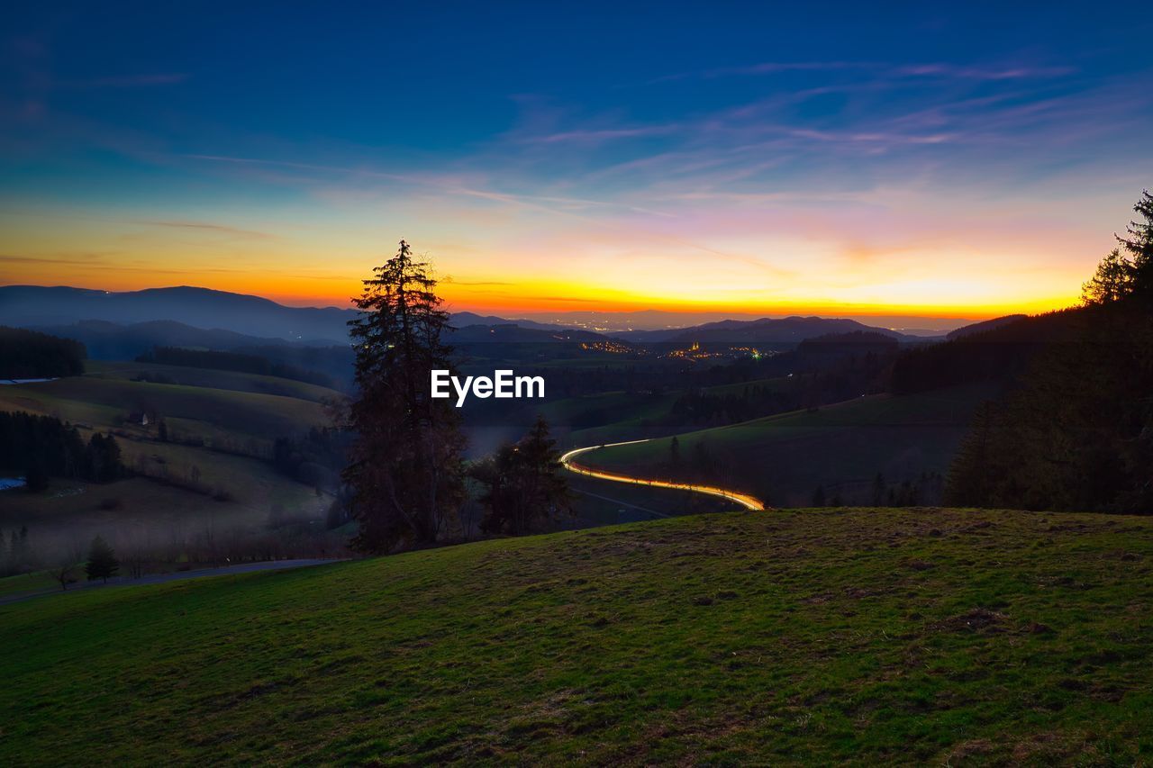 Scenic view of landscape against sky during sunset