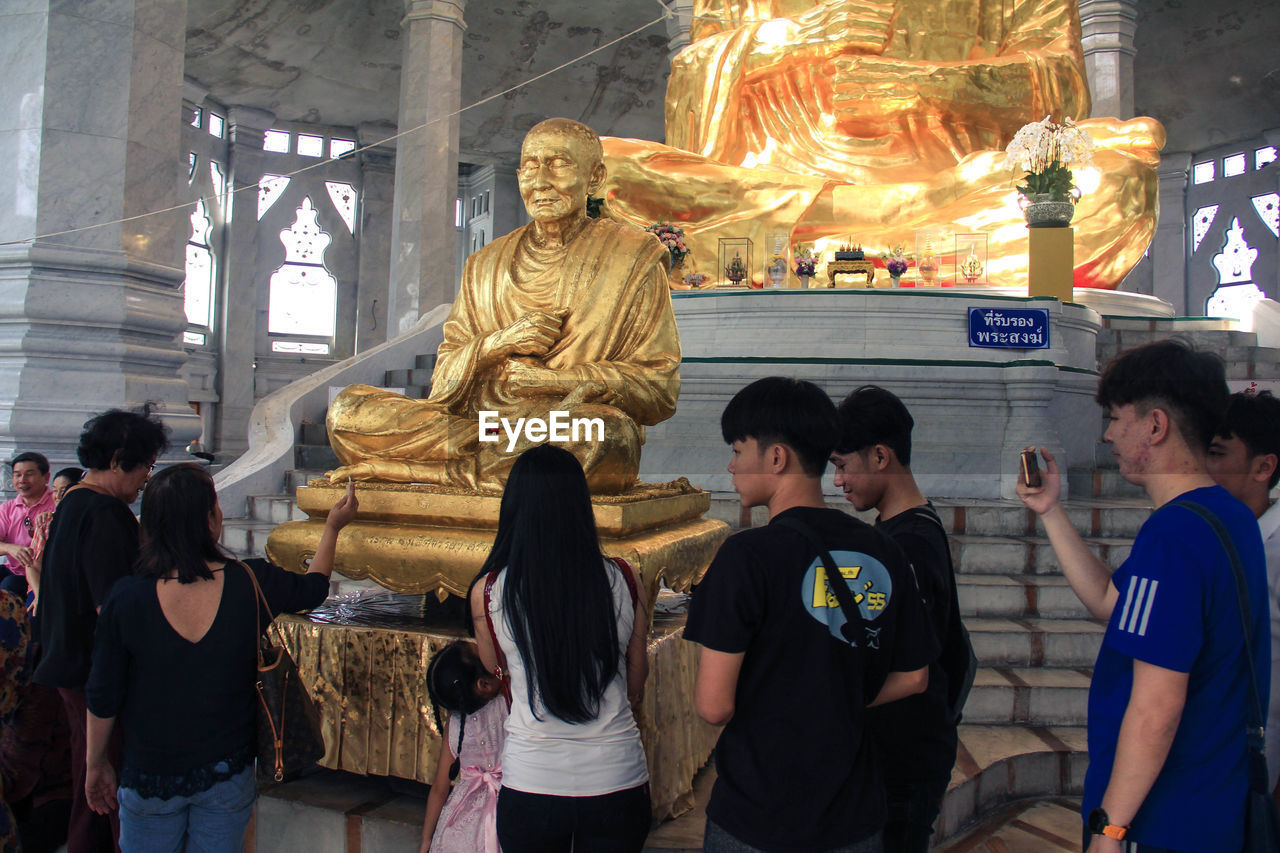 GROUP OF PEOPLE IN TRADITIONAL TEMPLE