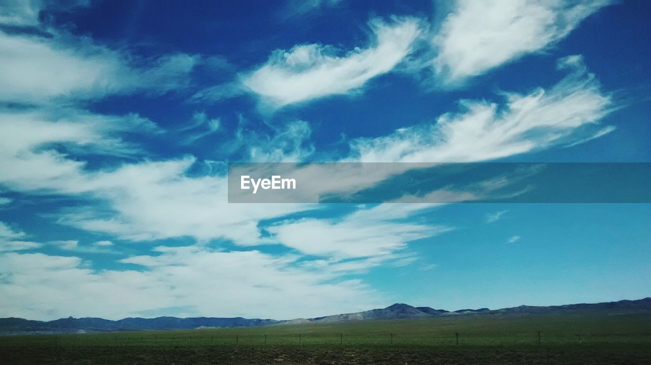 Scenic view of landscape against cloudy sky