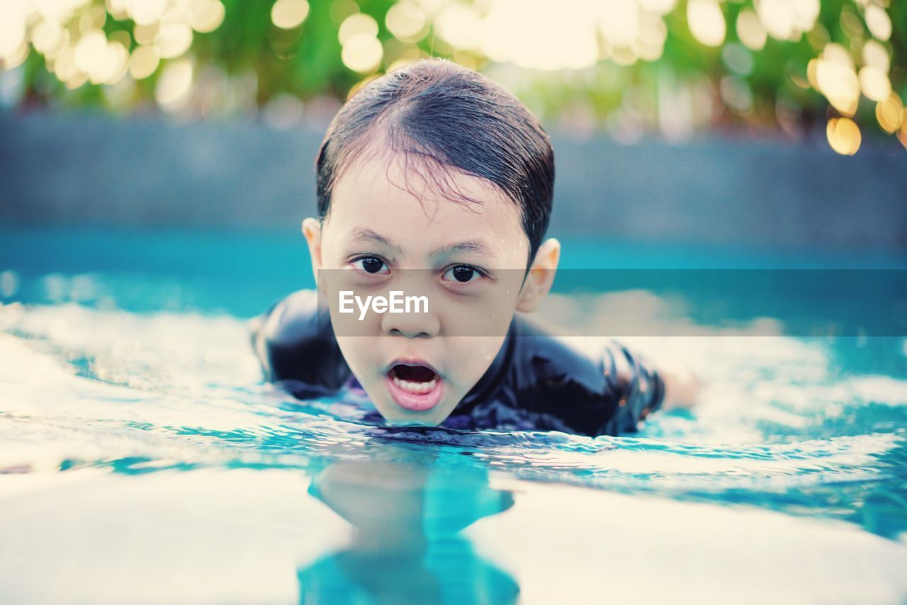 Portrait of boy swimming in pool