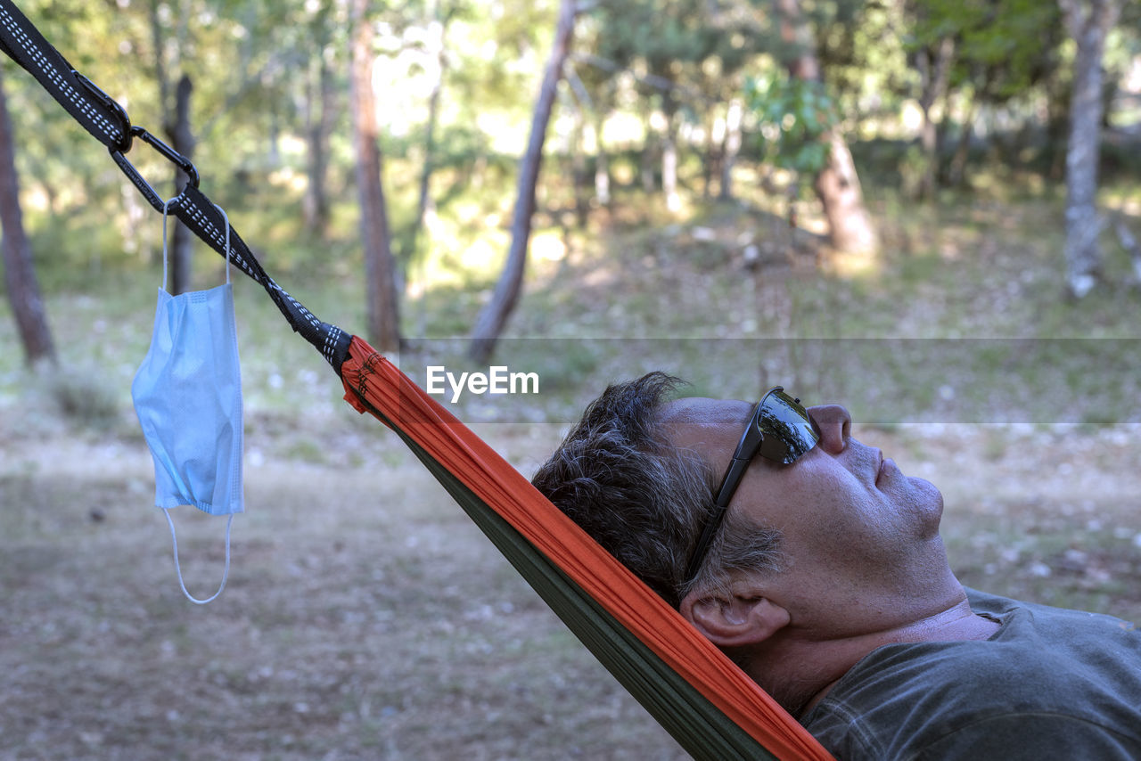 PORTRAIT OF MAN HOLDING SWING