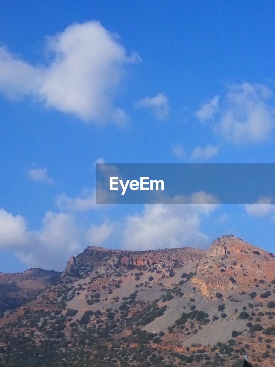 View of desert against cloudy sky