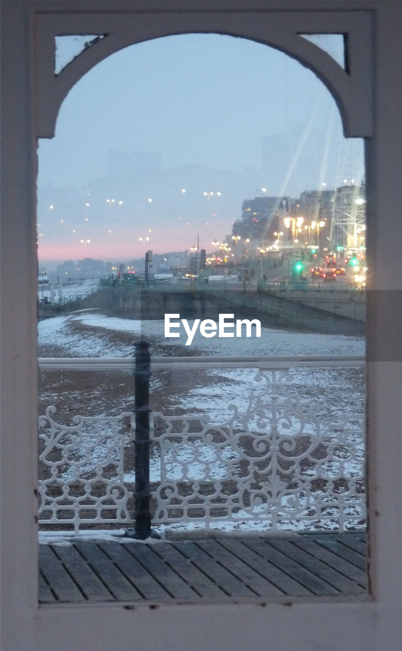 VIEW OF CITYSCAPE SEEN THROUGH WINDOW