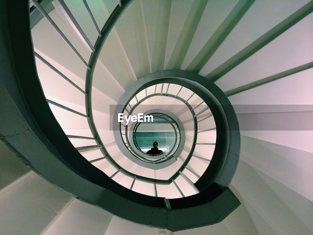 LOW ANGLE VIEW OF SPIRAL STAIRCASE IN BUILDING