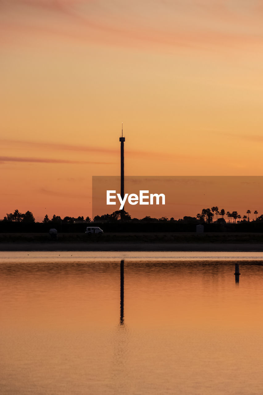 SCENIC VIEW OF LAKE AGAINST SKY AT SUNSET