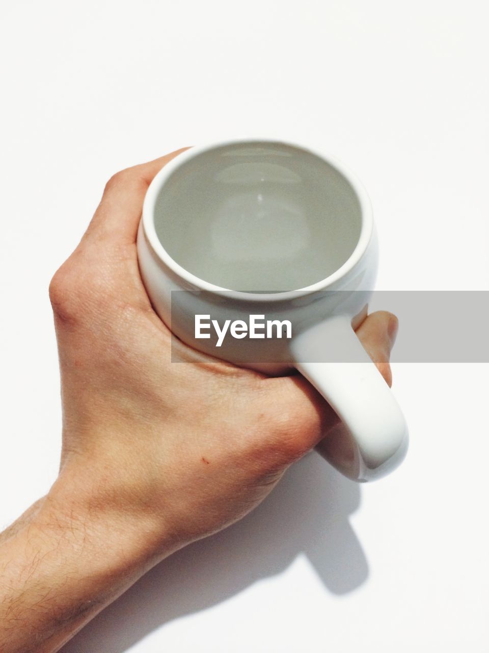 Cropped image of man holding tea cup against white background
