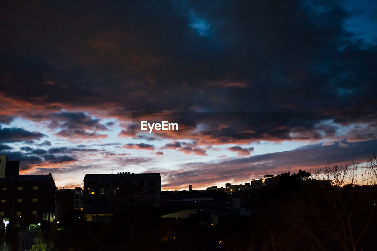 HOUSES AGAINST SKY DURING NIGHT