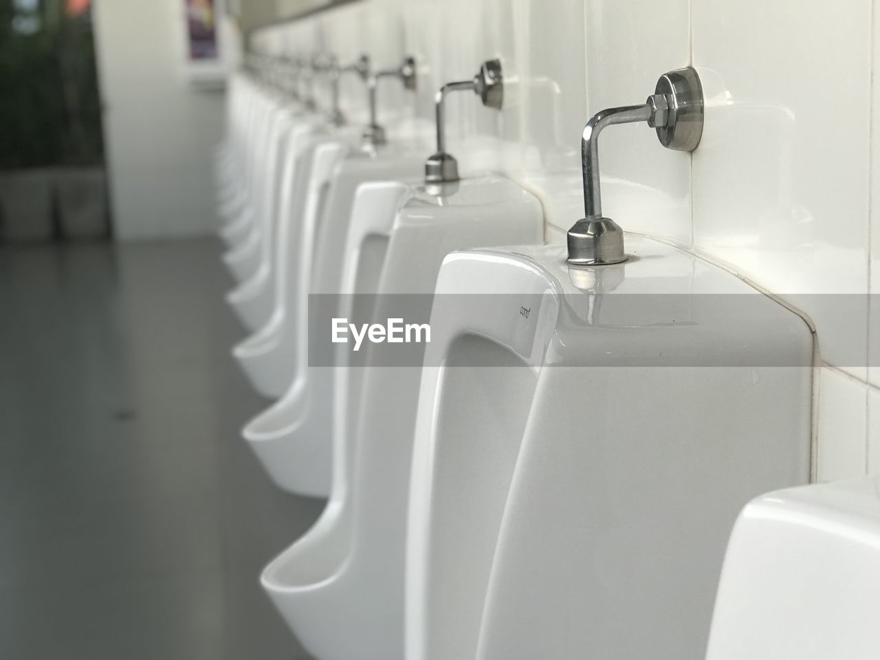 Close-up of urinals in bathroom
