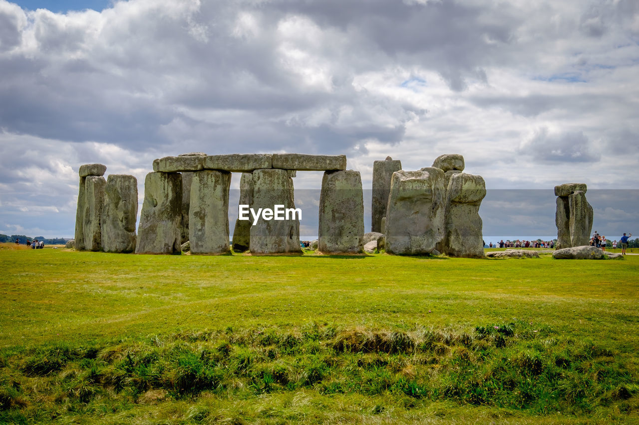 Stonehenge on field against sky