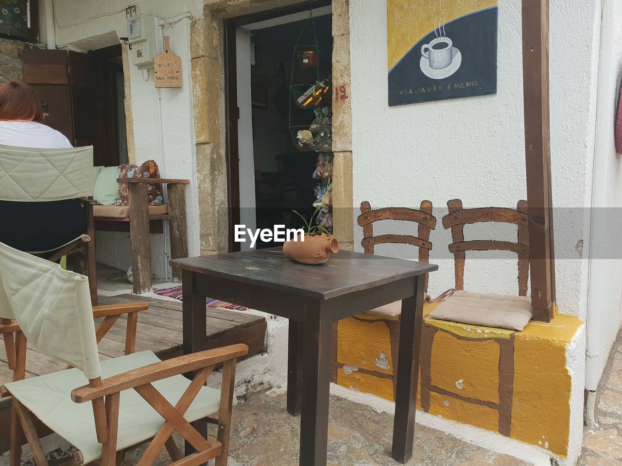 CHAIRS AND TABLES ON TABLE AT ENTRANCE OF STORE