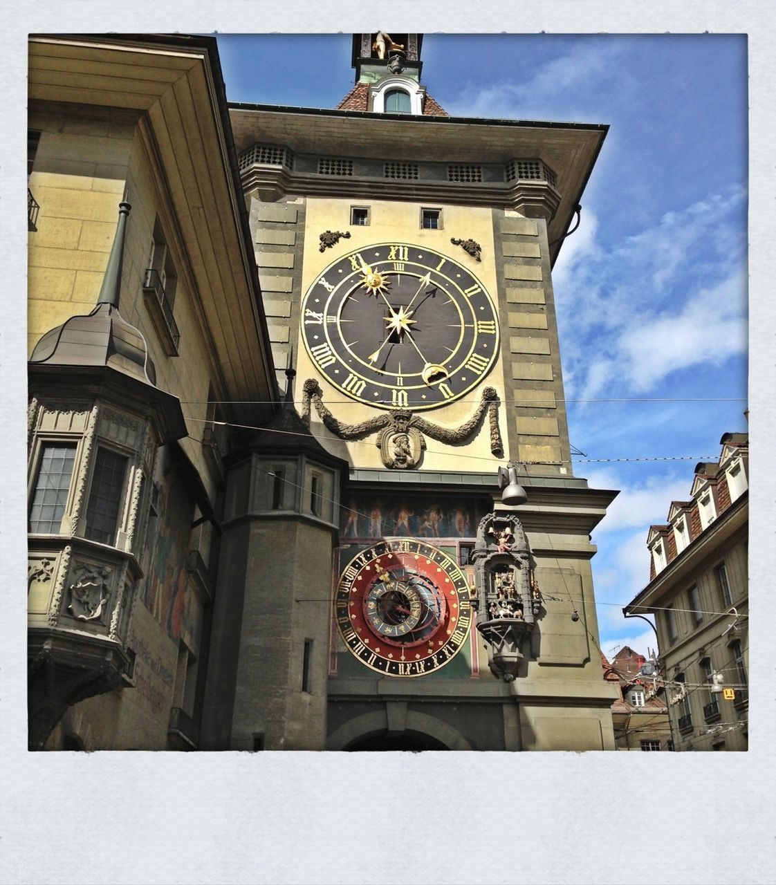 LOW ANGLE VIEW OF CLOCK TOWER AGAINST THE SKY