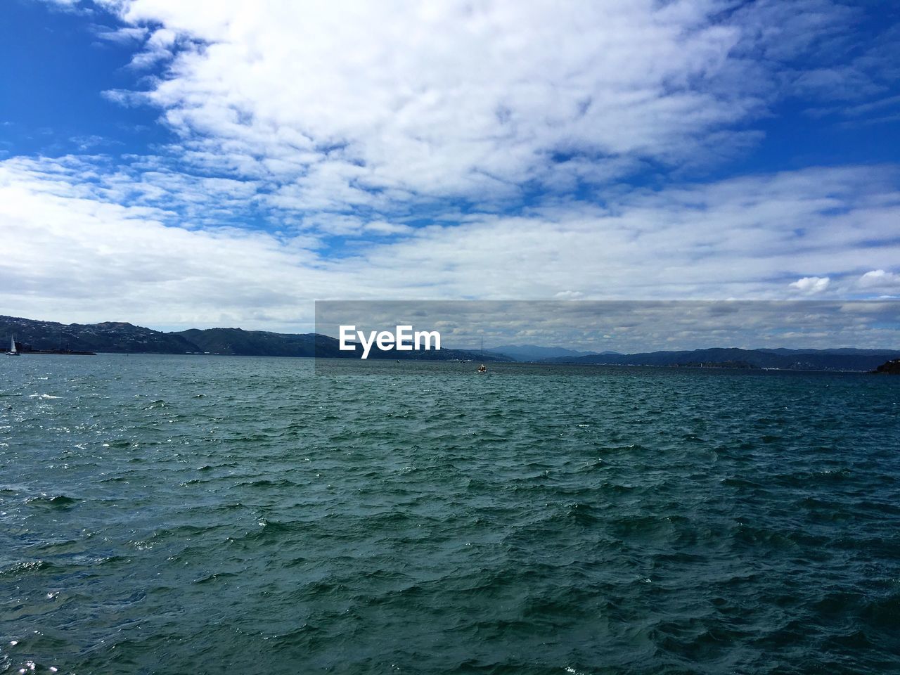 VIEW OF SEA AGAINST CLOUDY SKY