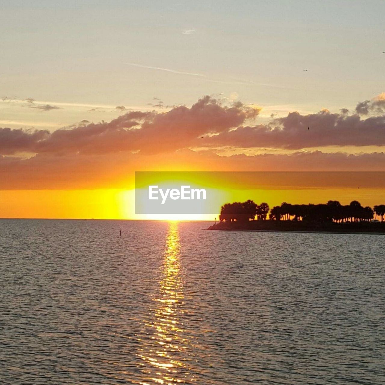 SCENIC VIEW OF SEA AGAINST ORANGE SKY DURING SUNSET