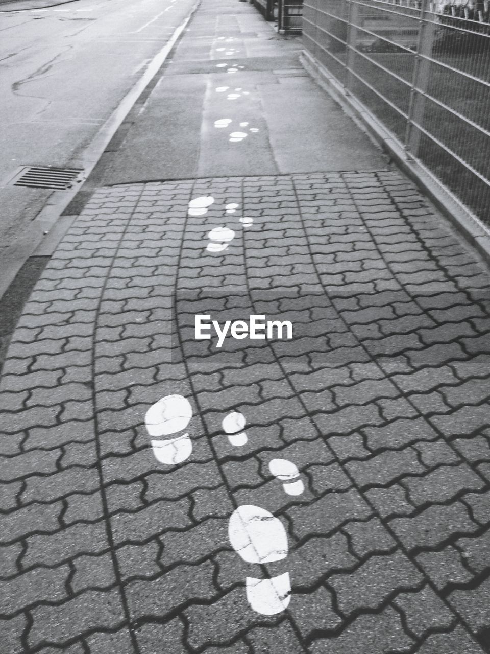 High angle view of footprints on sidewalk