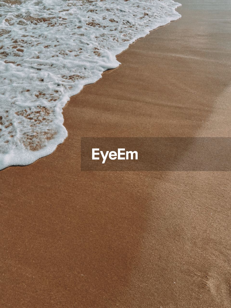 High angle view of surf on beach