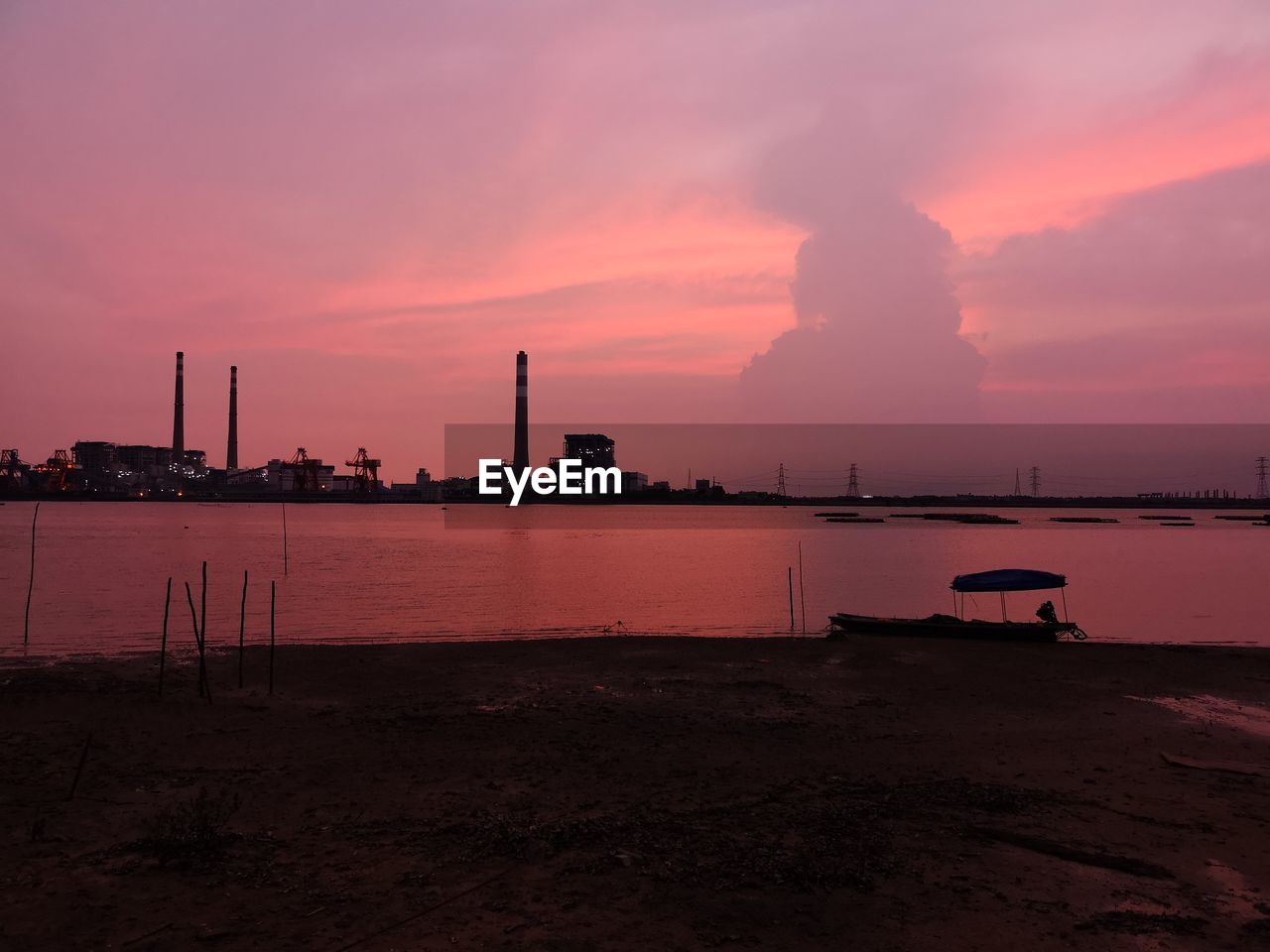 SMOKE EMITTING FROM FACTORY AT SUNSET