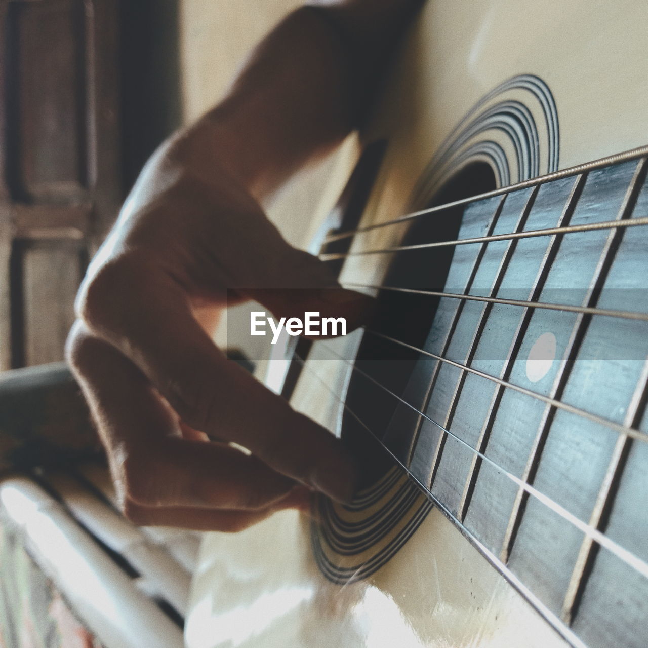 Cropped hand of person playing guitar