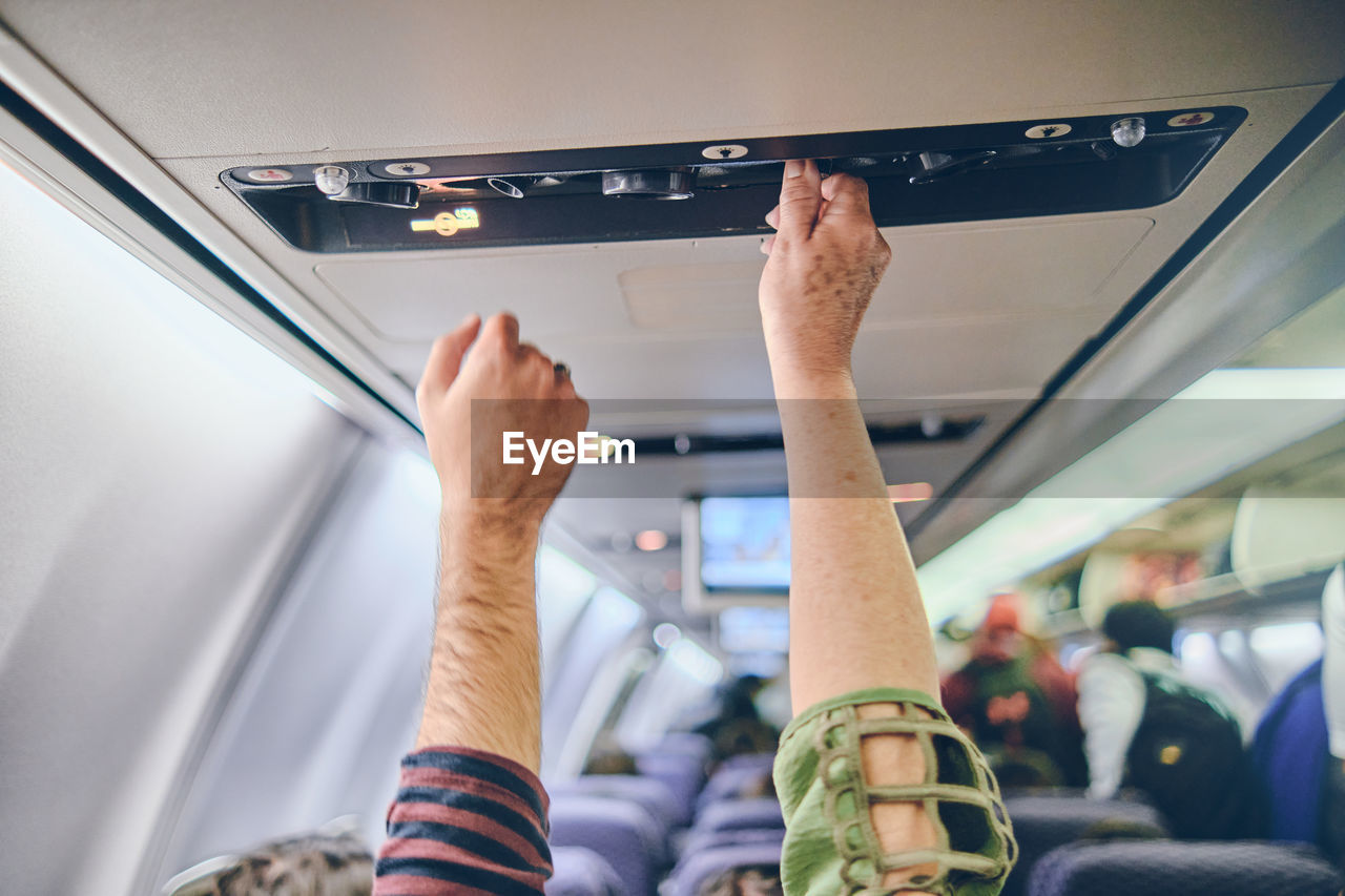 Hand up to adjust console panel aircraft, selective focus. travel concept