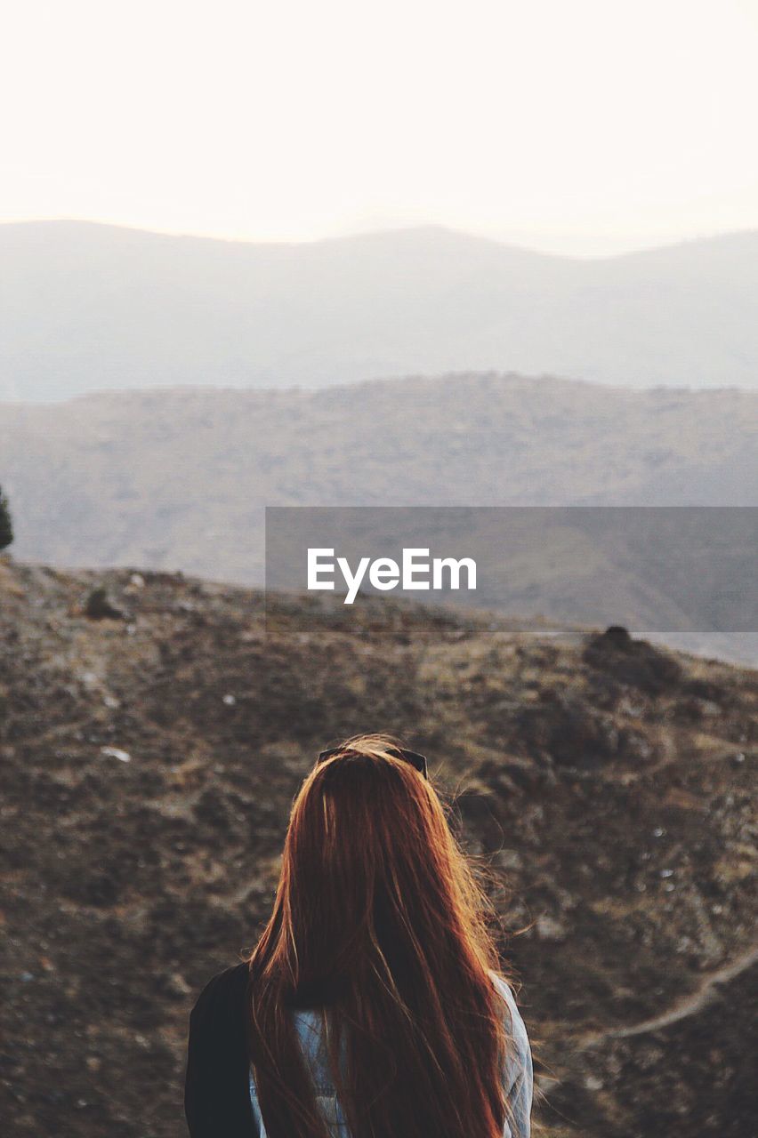 Rear view of woman looking at mountains