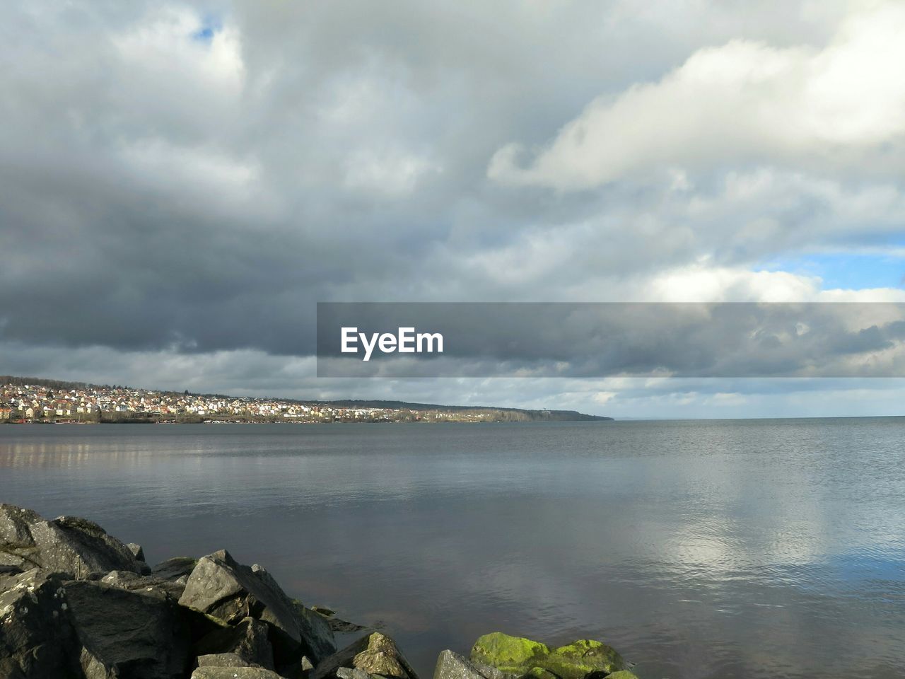 View of calm sea against clouds