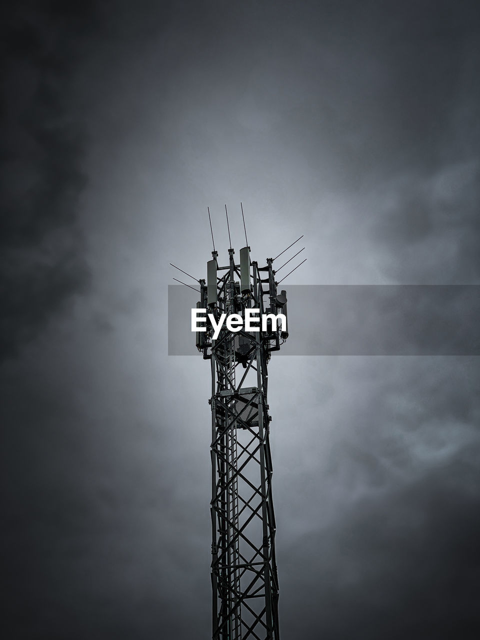 Low angle view of communications tower against sky