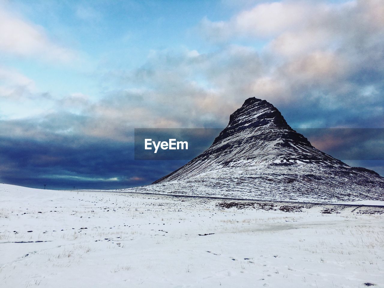 Scenic view of snowcapped mountain against sky