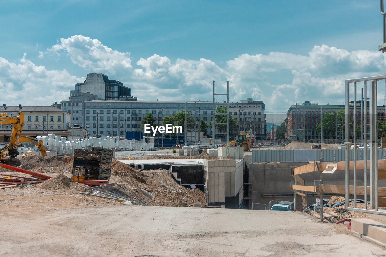 construction, architecture, industry, construction industry, sky, built structure, construction site, cloud, building exterior, city, development, nature, urban area, business finance and industry, building, sport venue, machinery, day, outdoors, stadium, arena, no people