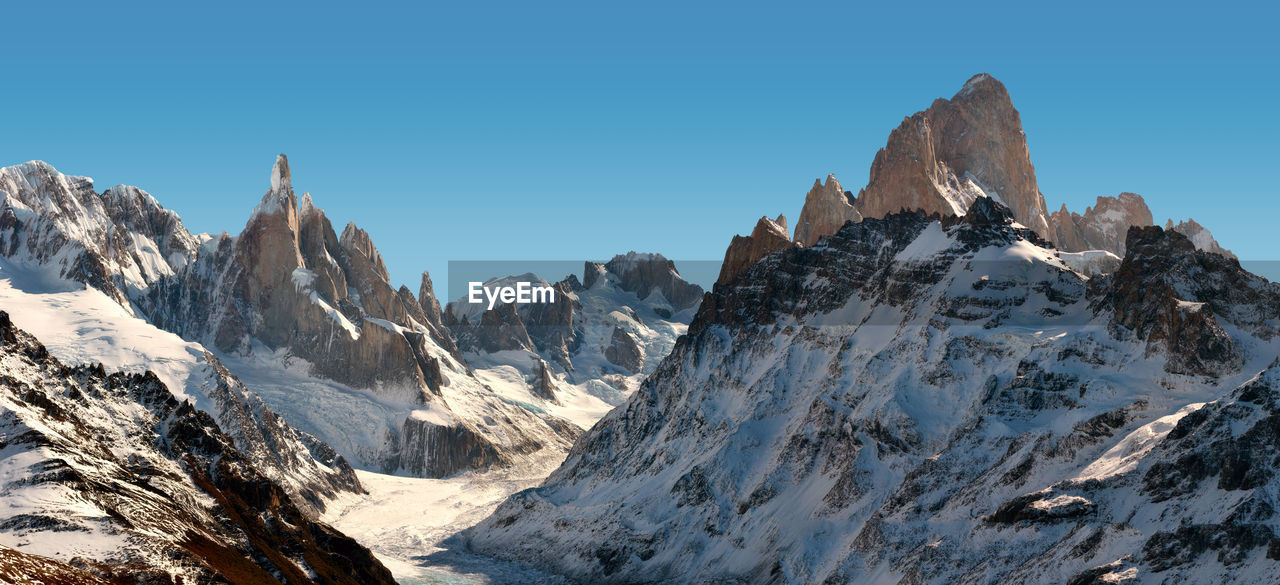 Scenic view of snowcapped mountains against clear sky