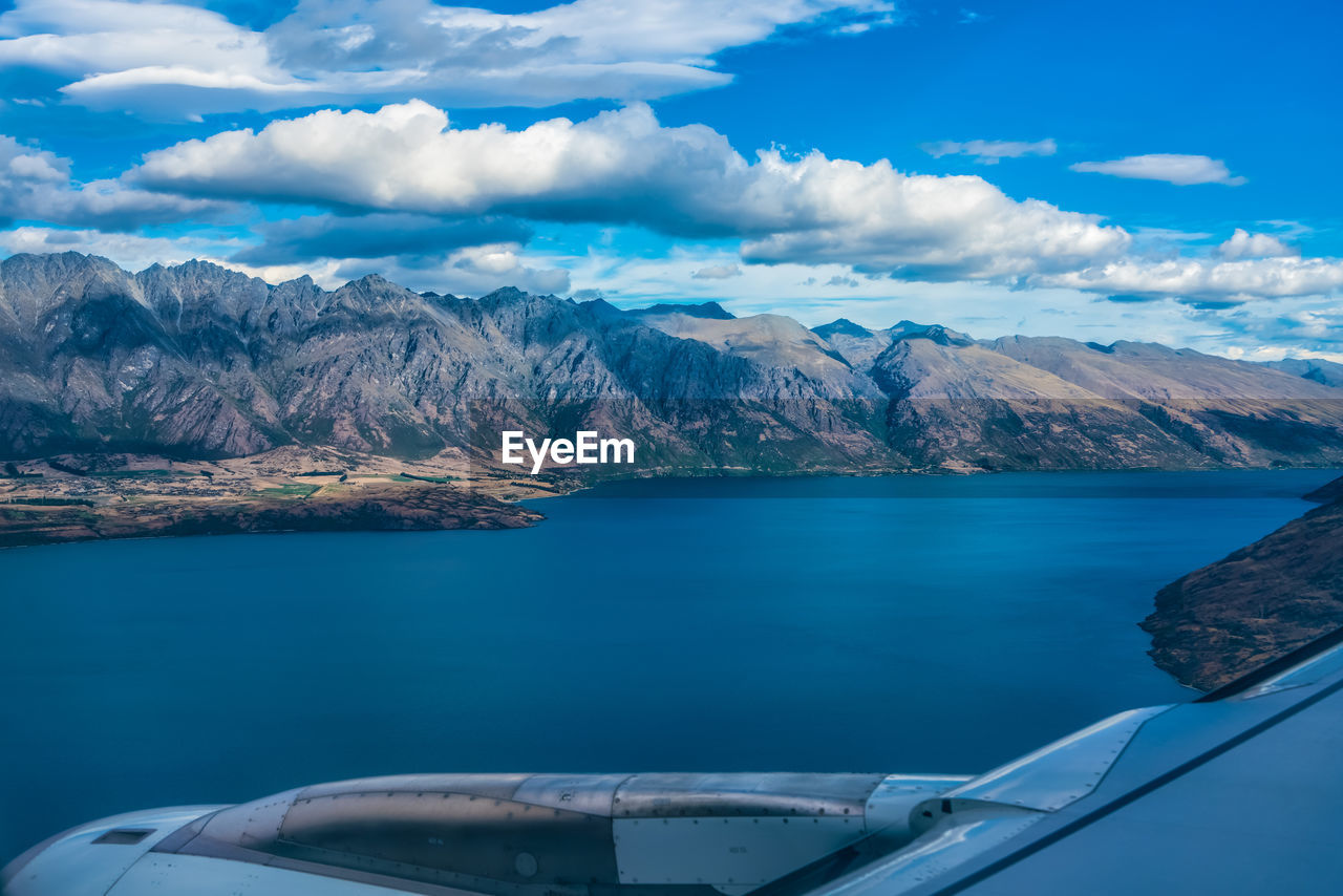 Boat in sea against mountains