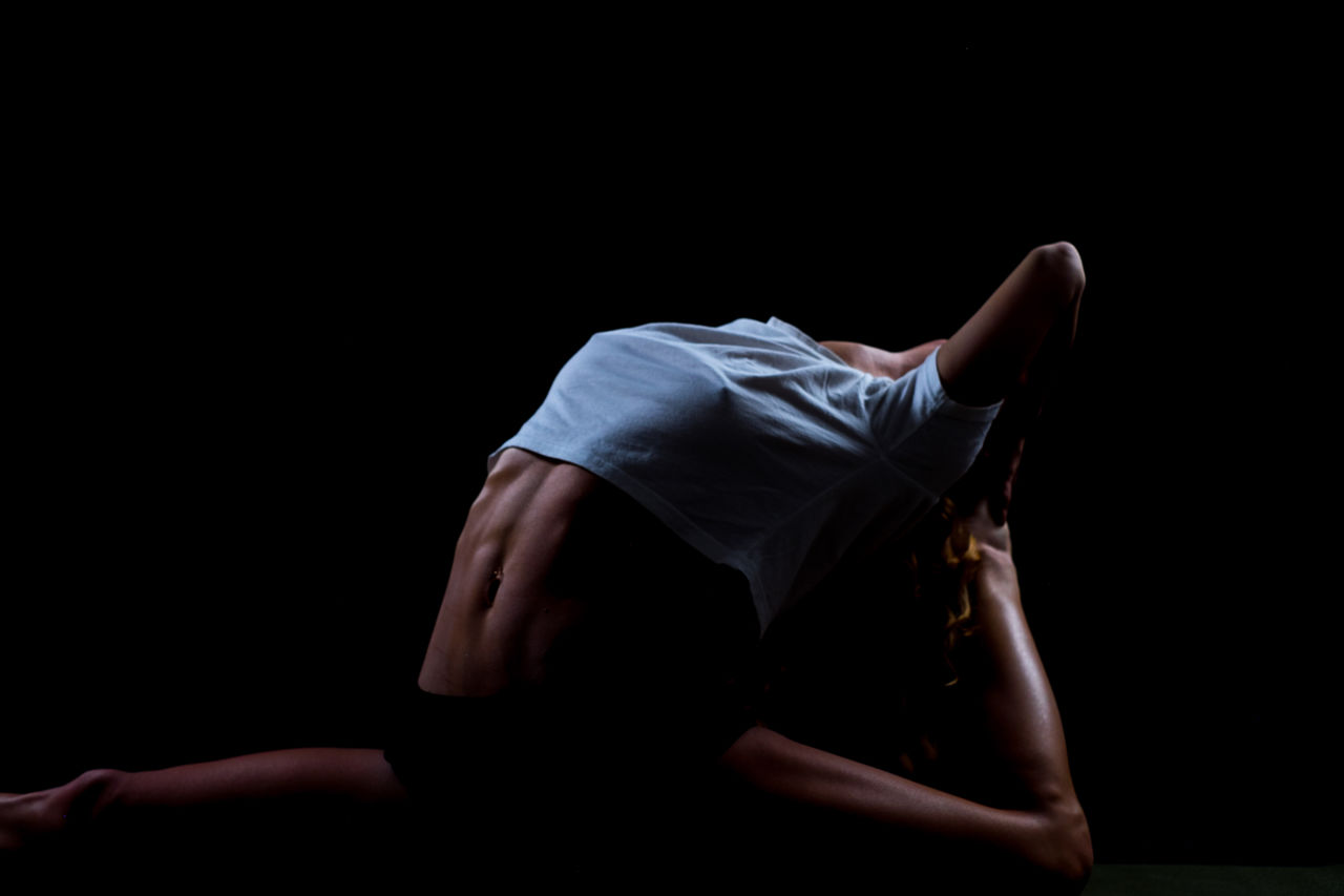 Woman dancer against black background