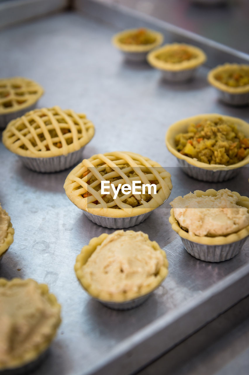 High angle view of tartlets in baking sheet